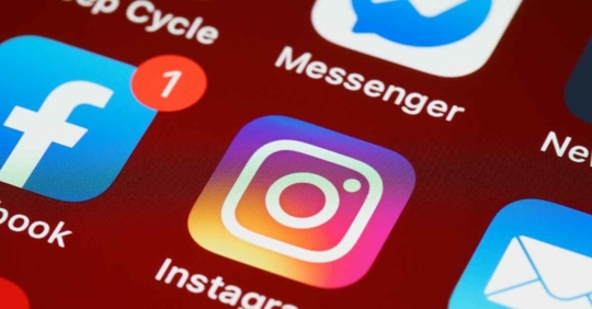 App logos on a phone, including Instagram, Facebook, and Messenger