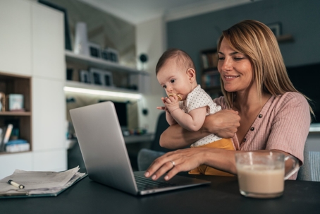 woman on laptop with baby