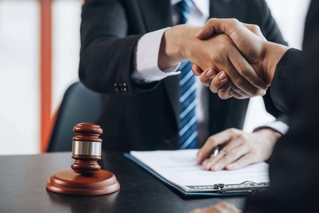 Lawyer shaking hands with client