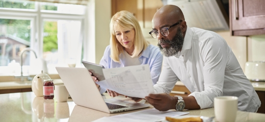 elderly couple reviewing documents