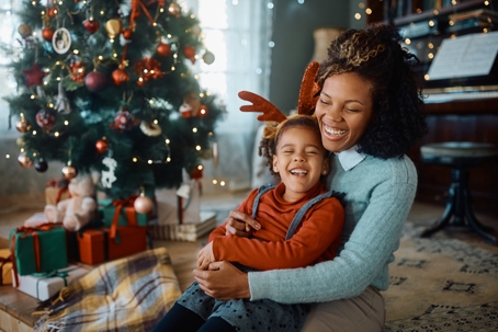 Mom and daughter in front of christmas tree