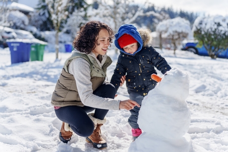 mother and child playing in the snow