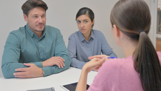 couple in a serious discussion with a professional