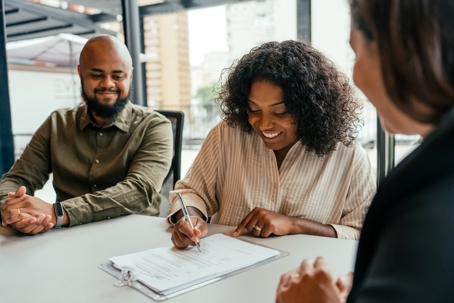 couple signing documents at lawyer's office