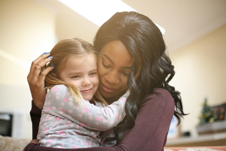 woman hugging small girl